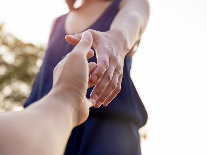 Female hands reaching out for help each other.