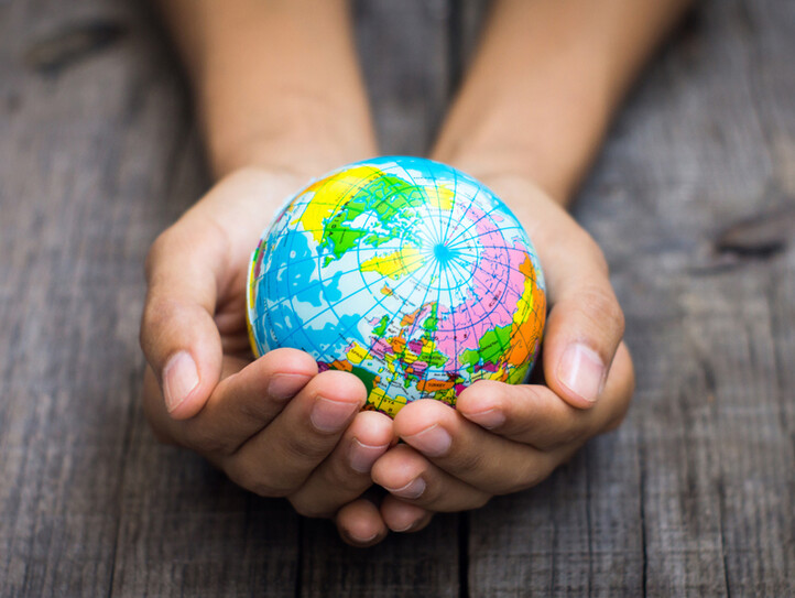 Person holding a globe