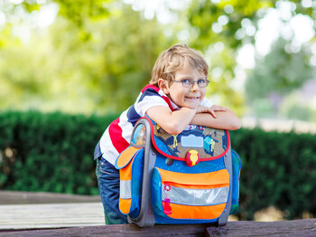 Happy,Little,Kid,Boy,With,Glasses,And,Backpack,Or,Satchel
